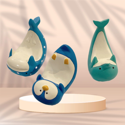 Whimsical Waves Phone Stand: A Tale of Playful Dolphins, Majestic Whales, and Charming Penguins